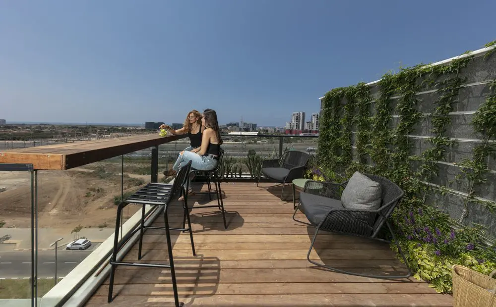 מרפסת מעוצבת עם קיר ירוק